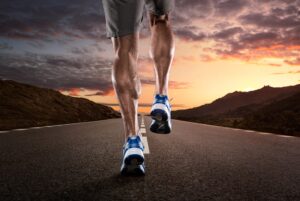 exercise calorie burn 300x201 - Close up of athlete's legs running on the empty road at the sunset